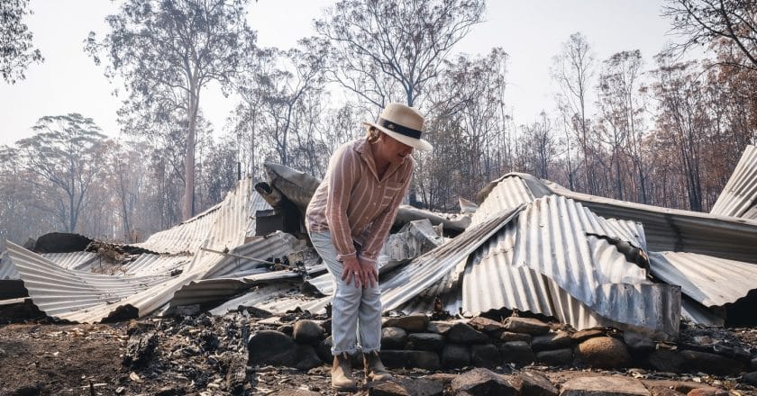 Bushfire survivor Melinda Plesman inspects the damage to her property at Nymboida southwest of Grafton in NSW. 

Nearly 100 homes have been lost in devastating fires that hit the community on Nov 8, 2019.